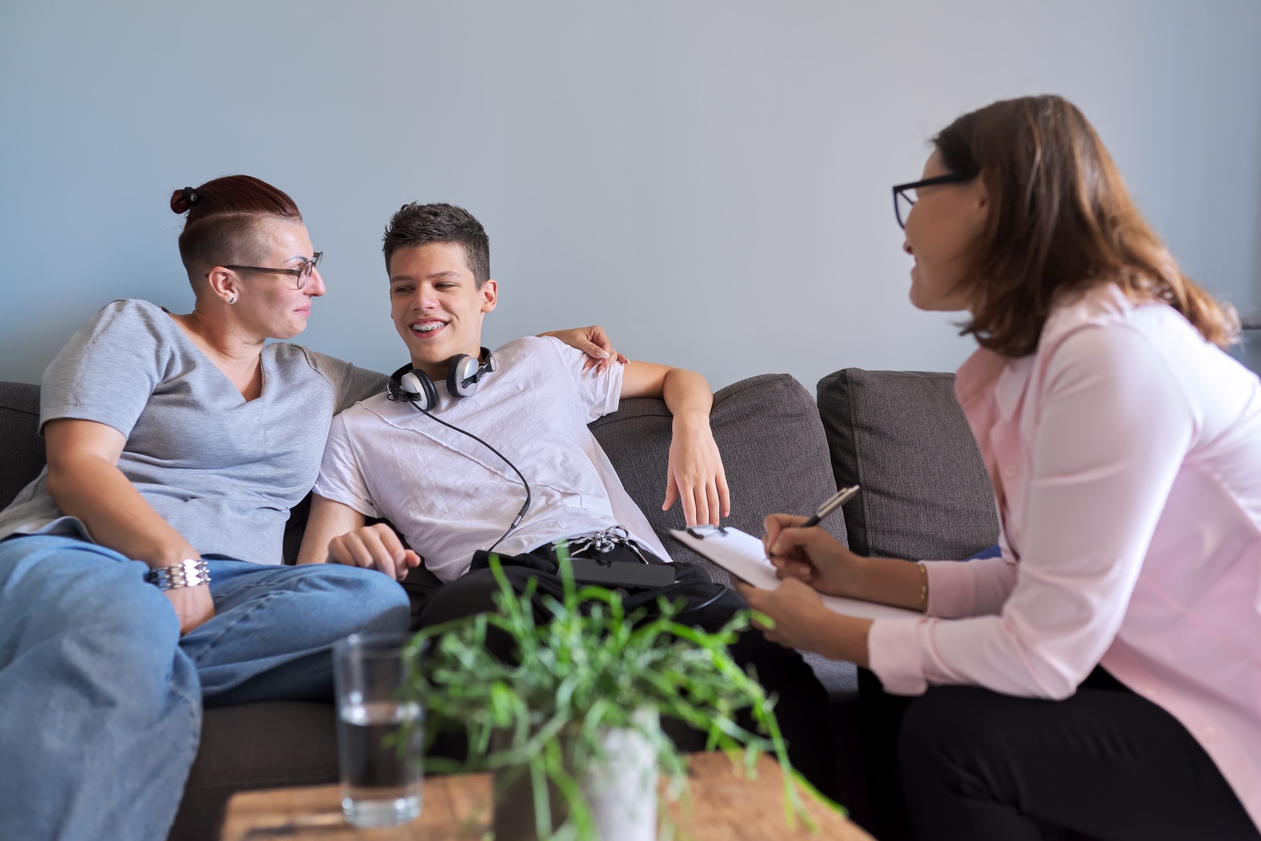 Mother with her teenage son at meeting with social worker, psychologist